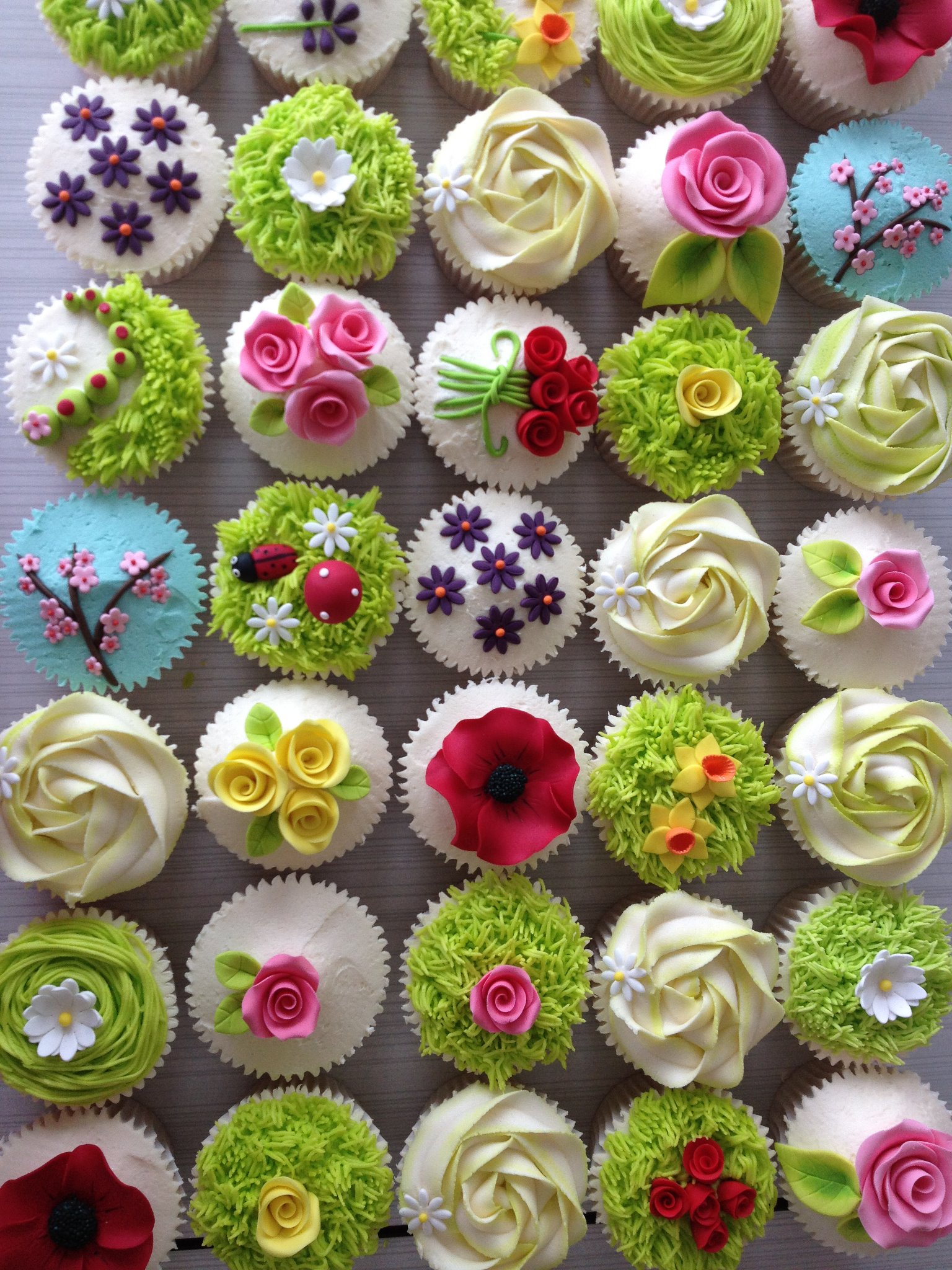 Collection of colourfully decorated cupcakes